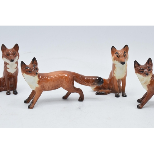 161 - A collection of Beswick foxes to include standing fox 1440 x 2 and seated fox 1748 x 3 (5) with some... 