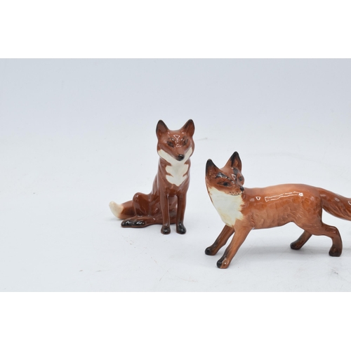 161 - A collection of Beswick foxes to include standing fox 1440 x 2 and seated fox 1748 x 3 (5) with some... 