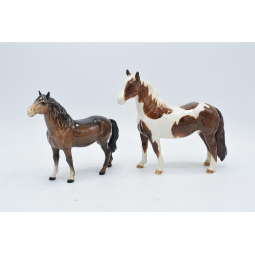 163 - Beswick skewbald pinto pony 1373 together with head up pony 1197 (2). In good condition with no obvi... 