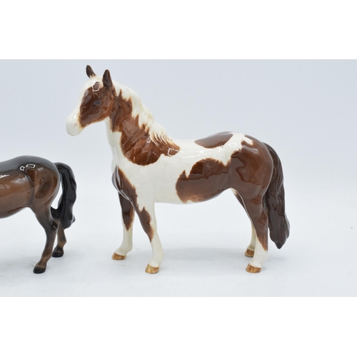 163 - Beswick skewbald pinto pony 1373 together with head up pony 1197 (2). In good condition with no obvi... 