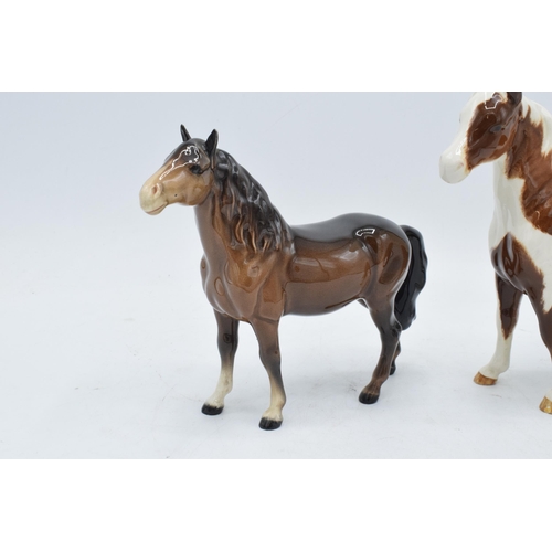 163 - Beswick skewbald pinto pony 1373 together with head up pony 1197 (2). In good condition with no obvi... 