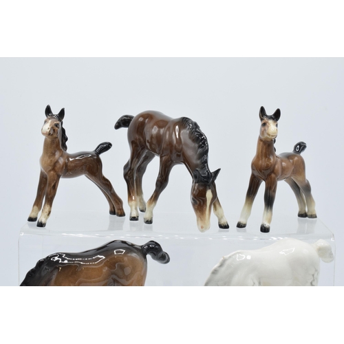 164 - A collection of Beswick ponies to include grazing pony 946 in palomino, 3 brown examples and a dappl... 