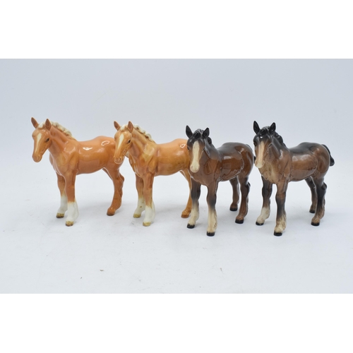 165 - A collection of Beswick shire foals 1053 to include 2 brown examples and 2 palomino examples (4). In... 