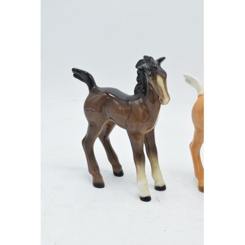 167 - A collection of Beswick comical-type foal 728 in various colourways to include brown, grey and palom... 