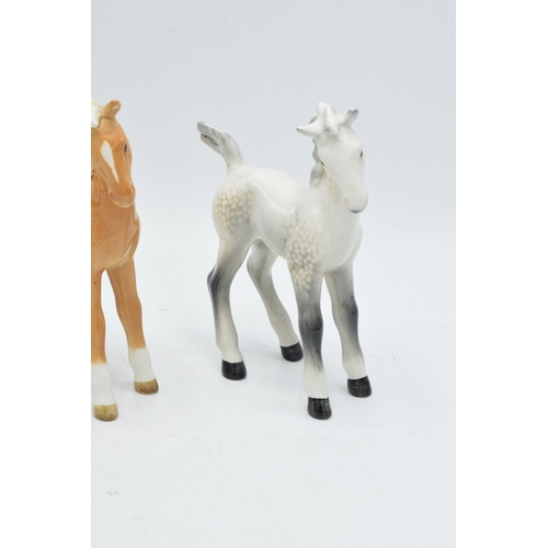 167 - A collection of Beswick comical-type foal 728 in various colourways to include brown, grey and palom... 