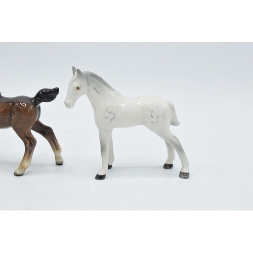 168 - A collection of Beswick horses to include grey thoroughbred foal, brown stretched foal facing left a... 