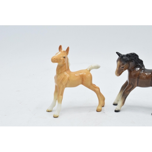 168 - A collection of Beswick horses to include grey thoroughbred foal, brown stretched foal facing left a... 