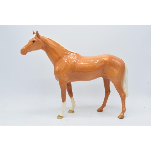 186A - Beswick large palomino racehorse 1564. In good condition with no obvious damage though the back left... 