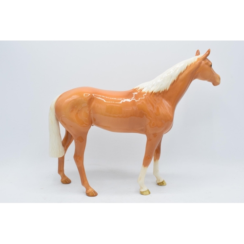 186A - Beswick large palomino racehorse 1564. In good condition with no obvious damage though the back left... 