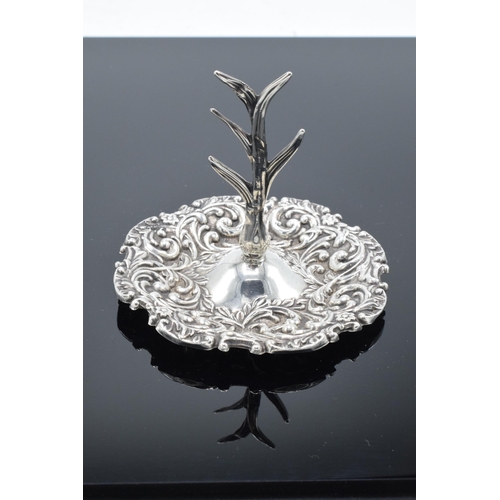 205 - A silver ring tree with repousse decoration. Birmingham 1909. 25.9 grams.