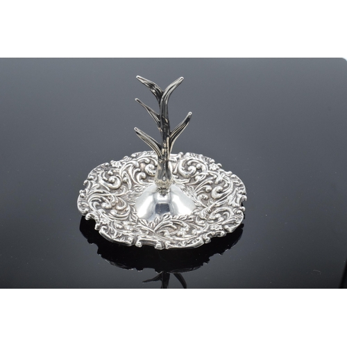 205 - A silver ring tree with repousse decoration. Birmingham 1909. 25.9 grams.