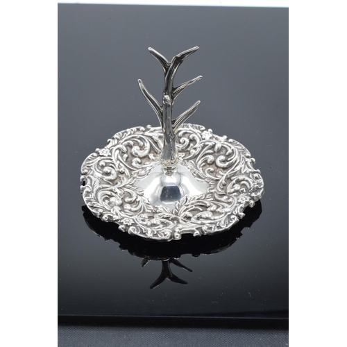 205 - A silver ring tree with repousse decoration. Birmingham 1909. 25.9 grams.