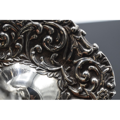 205 - A silver ring tree with repousse decoration. Birmingham 1909. 25.9 grams.