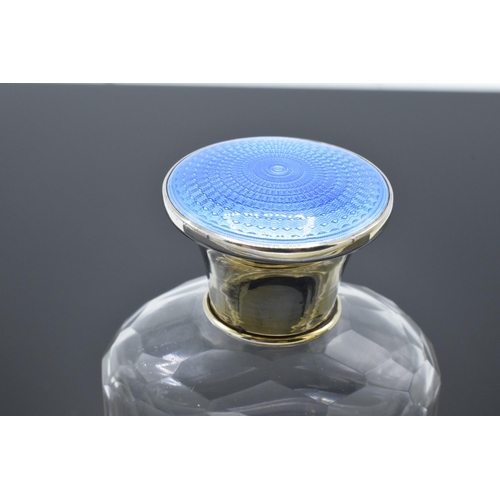 206 - Silver glass scent bottle with a blue enamelled lid. Birmingham 1928. In good condition. Minor loss ... 