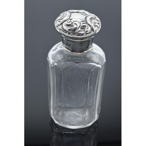 210 - Edwardian glass scent bottle with a silver screw top lid with repousse decoration. London 1904. 10cm... 