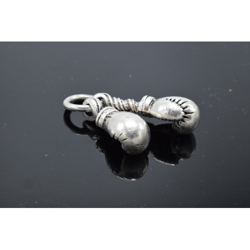 216 - An unusual pair of silver charms in the form of boxing gloves. 19.0 grams.