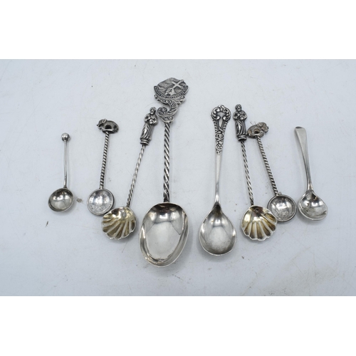 233 - A collection of silver coloured and hallmarked silver mustard and similar spoons (8). 44.1 grams.