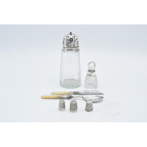 234 - A collection of silver items to include a silver topped shaker, a perfume bottle with a silver neck,... 