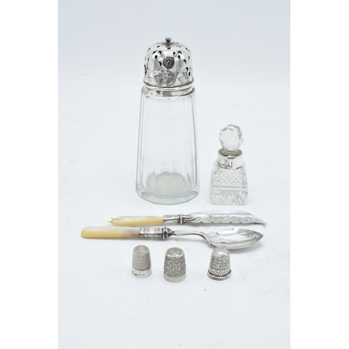 234 - A collection of silver items to include a silver topped shaker, a perfume bottle with a silver neck,... 