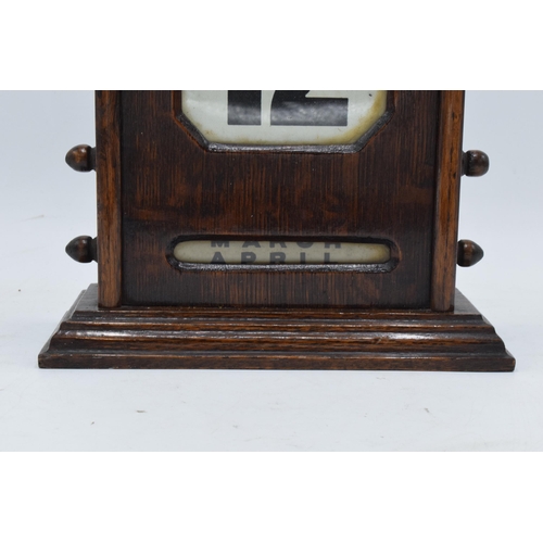 236 - An early 20th century wooden perpetual calendar with separate scrolls for the day of the week, numbe... 