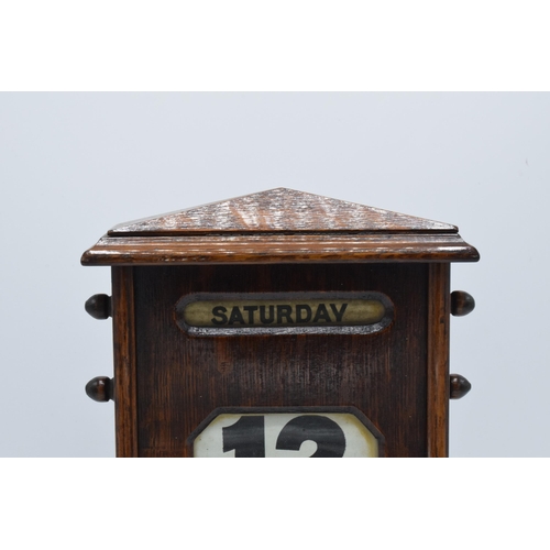 236 - An early 20th century wooden perpetual calendar with separate scrolls for the day of the week, numbe... 