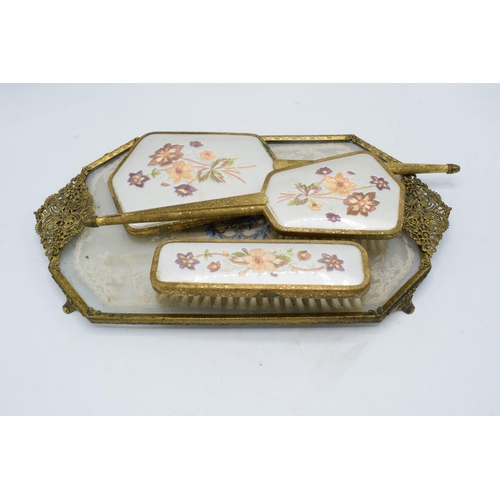 274 - A 20th century brass and gilt metal dressing table set with embroidered decoration to include brushe... 