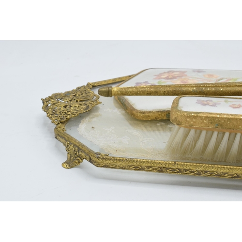 274 - A 20th century brass and gilt metal dressing table set with embroidered decoration to include brushe... 