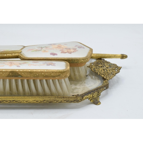 274 - A 20th century brass and gilt metal dressing table set with embroidered decoration to include brushe... 