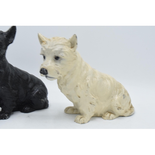 275 - A pair of painted cast metal dogs perhaps advertising Whyte and Mackay Whiskey. In good condition wi... 