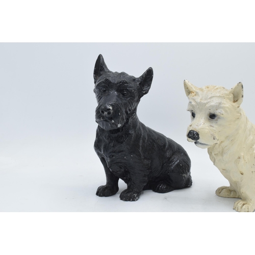 275 - A pair of painted cast metal dogs perhaps advertising Whyte and Mackay Whiskey. In good condition wi... 