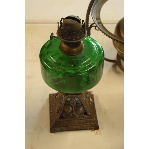 287 - A collection of 20th century oil lamps and burners of various forms to include examples with swingin... 