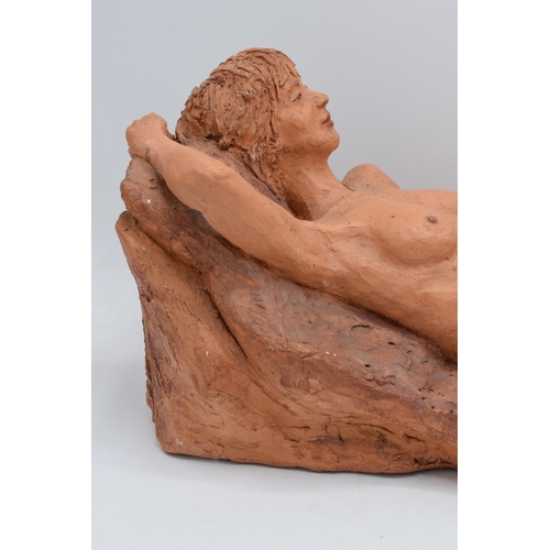 319 - Angela Munslow large clay figure of a naked lady lying down. 47cm long. In good condition with some ... 