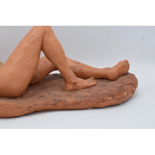 319 - Angela Munslow large clay figure of a naked lady lying down. 47cm long. In good condition with some ... 