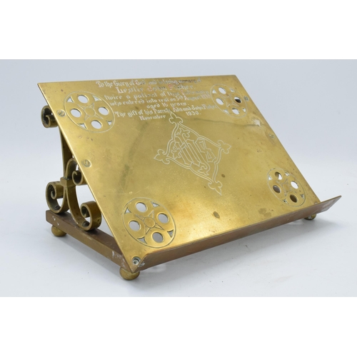 330 - A late 19th / early 20th century brass Bible stand with an inscription 'To the glory of God and in l... 