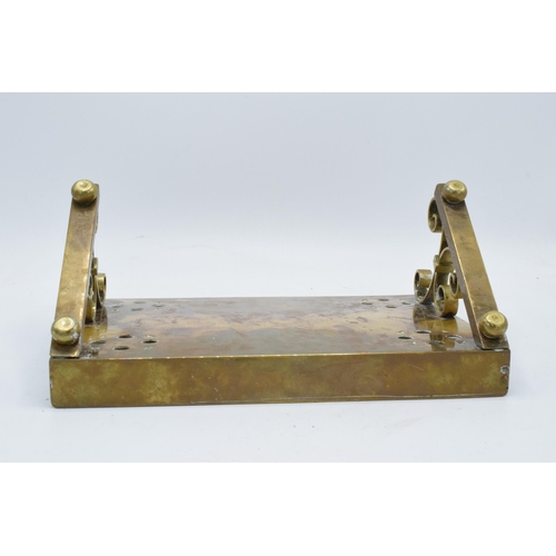 330 - A late 19th / early 20th century brass Bible stand with an inscription 'To the glory of God and in l... 