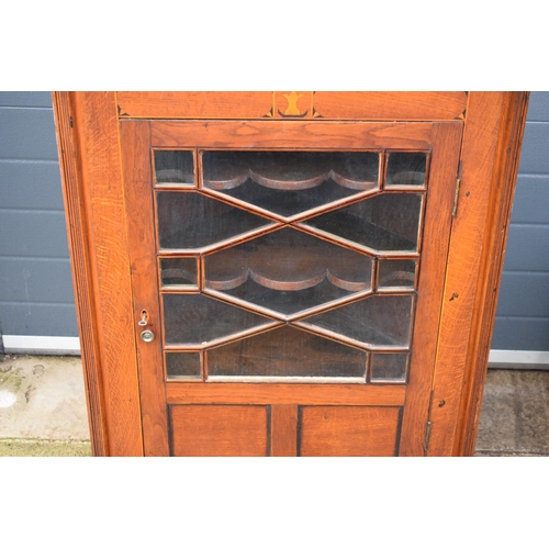 334 - A 19th century inlaid corner cabinet with astragal glazed door with swan neck pediment. 106cm tall. ... 