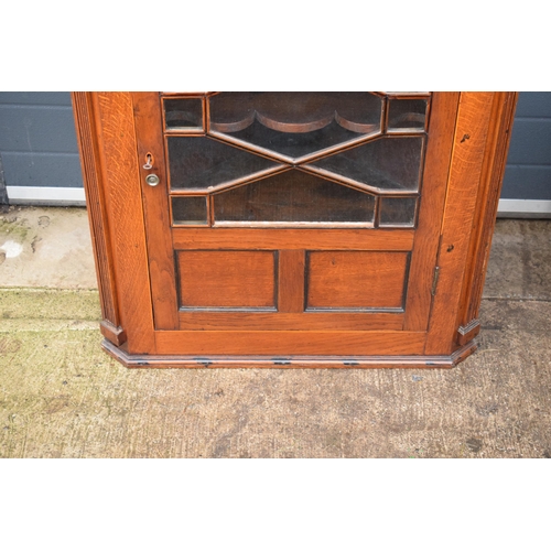 334 - A 19th century inlaid corner cabinet with astragal glazed door with swan neck pediment. 106cm tall. ... 