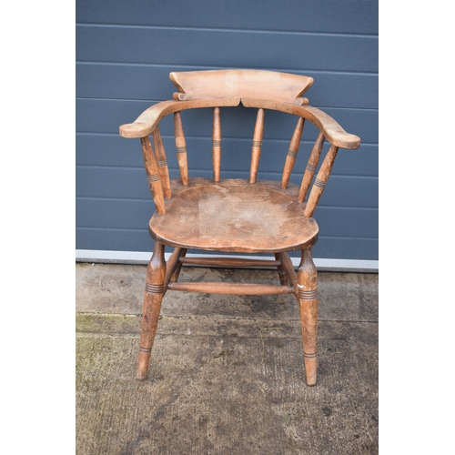 336 - A late 19th century elm or similar Captains bow back arm chair. 79cm tall. In good condition with si... 