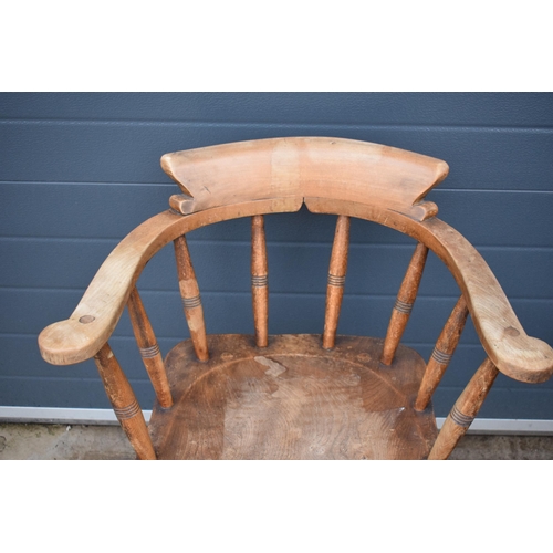 336 - A late 19th century elm or similar Captains bow back arm chair. 79cm tall. In good condition with si... 