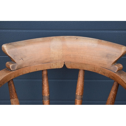 336 - A late 19th century elm or similar Captains bow back arm chair. 79cm tall. In good condition with si... 