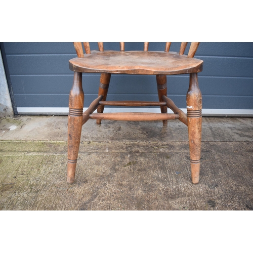 336 - A late 19th century elm or similar Captains bow back arm chair. 79cm tall. In good condition with si... 