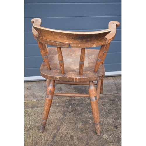 336 - A late 19th century elm or similar Captains bow back arm chair. 79cm tall. In good condition with si... 