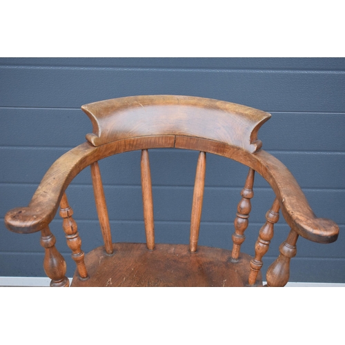 337 - A late 19th century elm or similar Captains bow back arm chair. 79cm tall. In good condition with si... 