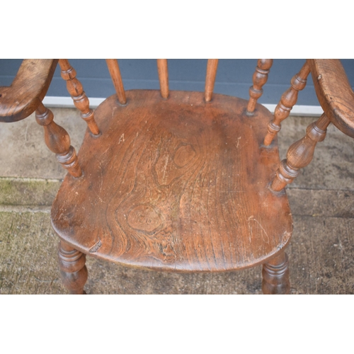 337 - A late 19th century elm or similar Captains bow back arm chair. 79cm tall. In good condition with si... 