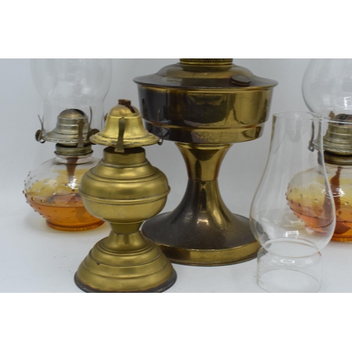 347 - A collection of vintage oil lamps to include brass examples with associated shades and chimneys (4).... 