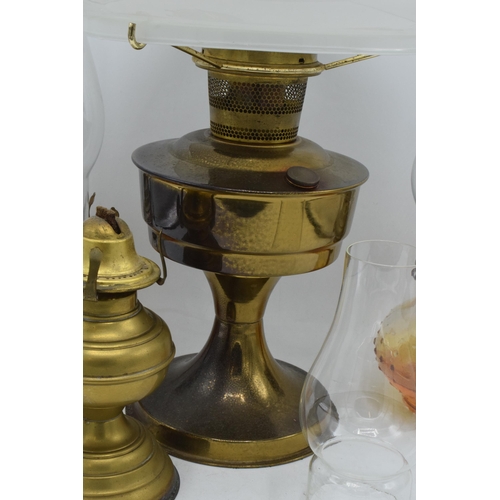 347 - A collection of vintage oil lamps to include brass examples with associated shades and chimneys (4).... 