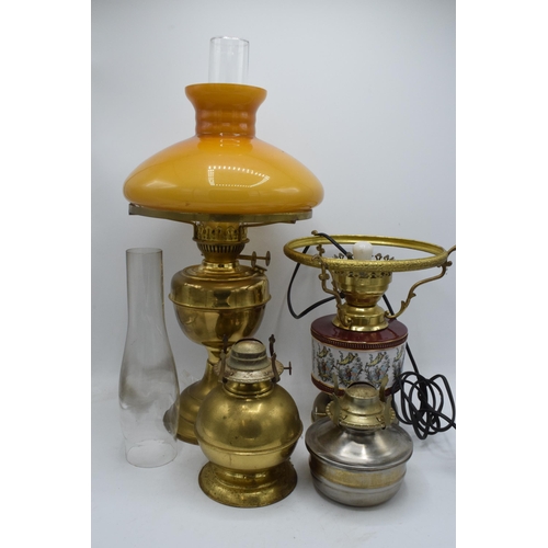 348 - A collection of vintage oil lamps to include brass and pottery examples with associated chimneys and... 