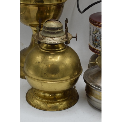 348 - A collection of vintage oil lamps to include brass and pottery examples with associated chimneys and... 