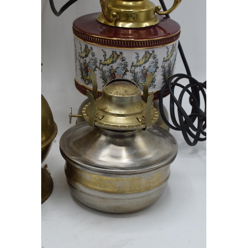 348 - A collection of vintage oil lamps to include brass and pottery examples with associated chimneys and... 