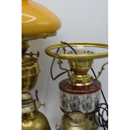 348 - A collection of vintage oil lamps to include brass and pottery examples with associated chimneys and... 